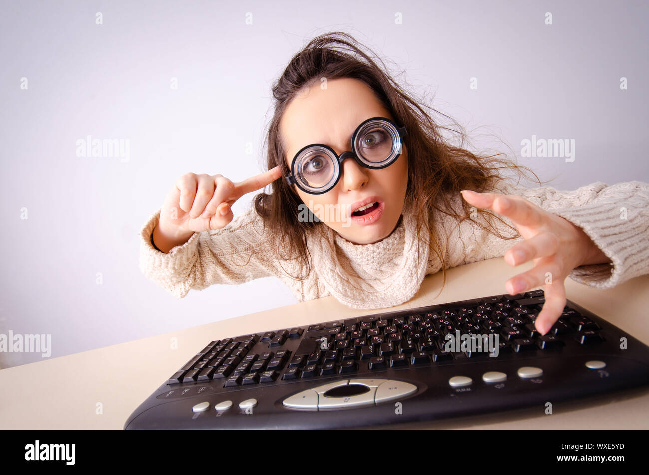 Funny nerd girl working on computer Stock Photo
