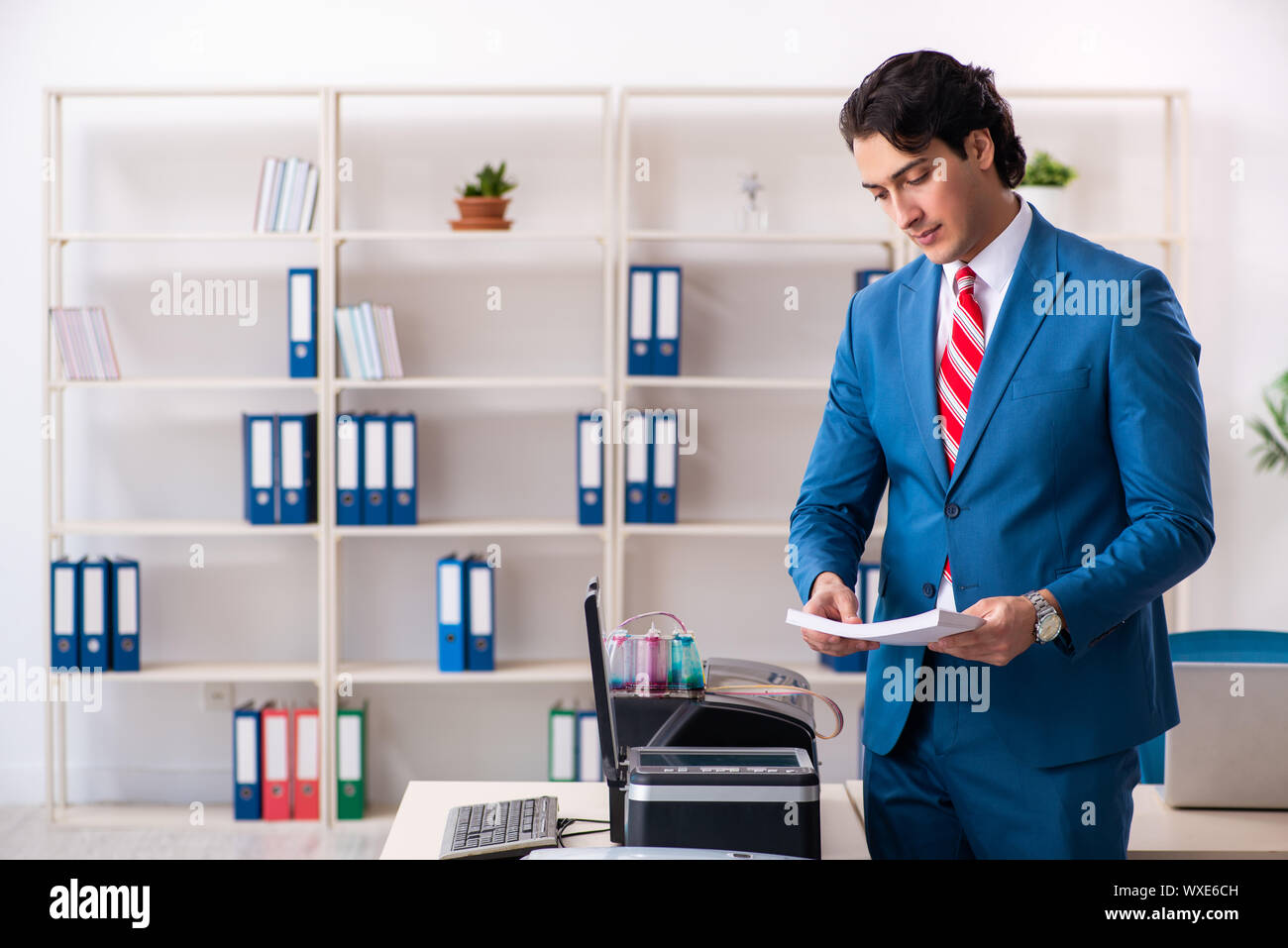 Working Copy Cop Young employee making copies at copying machine Stock Photo - Alamy