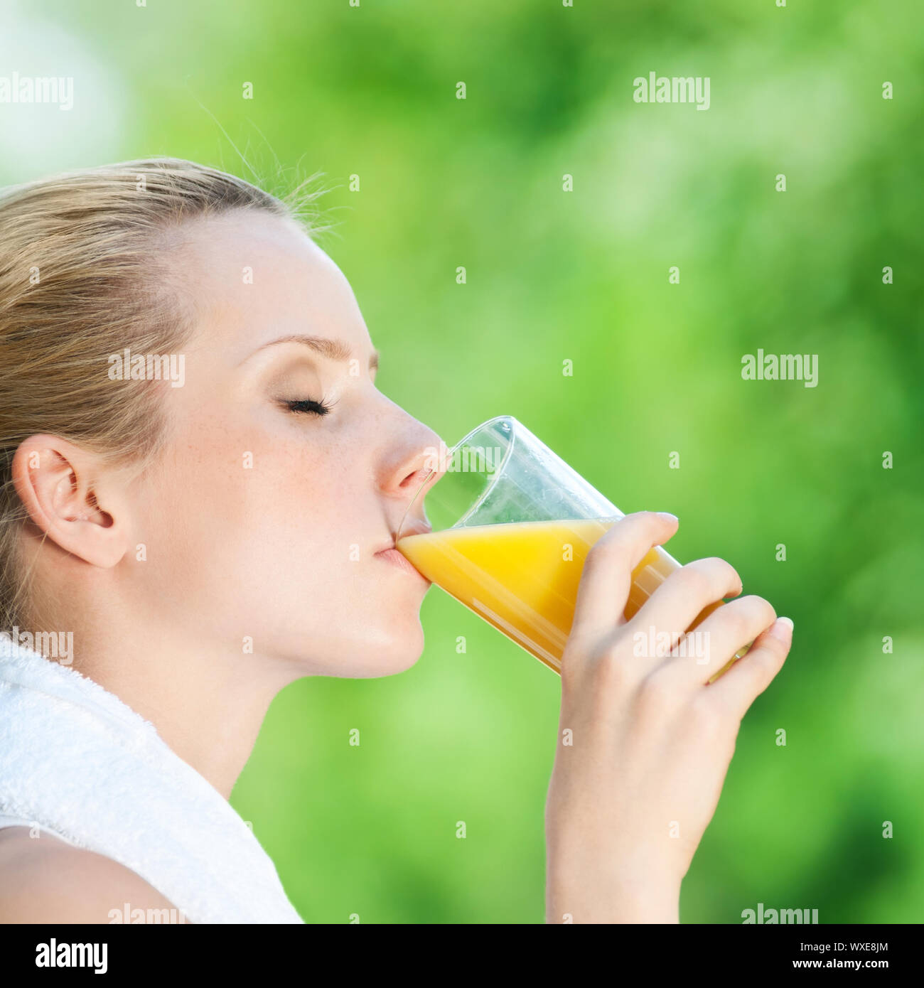 Young woman drinking orange juice after fitness exercise Stock Photo Alamy
