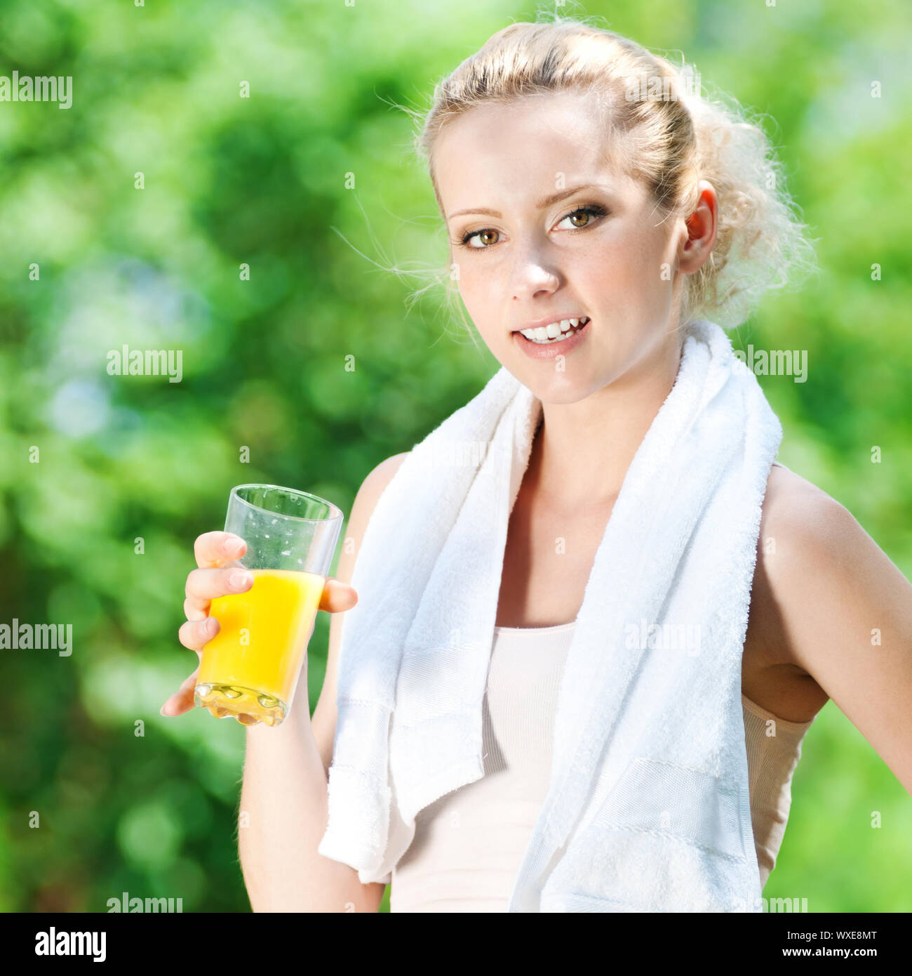 Young woman drinking orange juice after fitness exercise Stock Photo Alamy