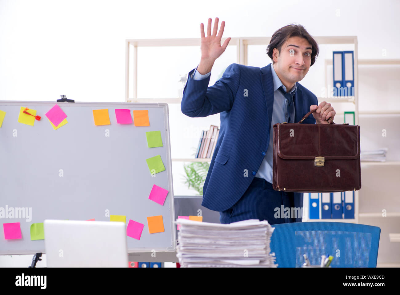 Young male employee unhappy with excessive work Stock Photo