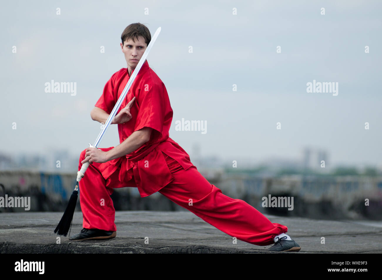 Shaolin warriors wushoo man in red with sword practice martial art ...