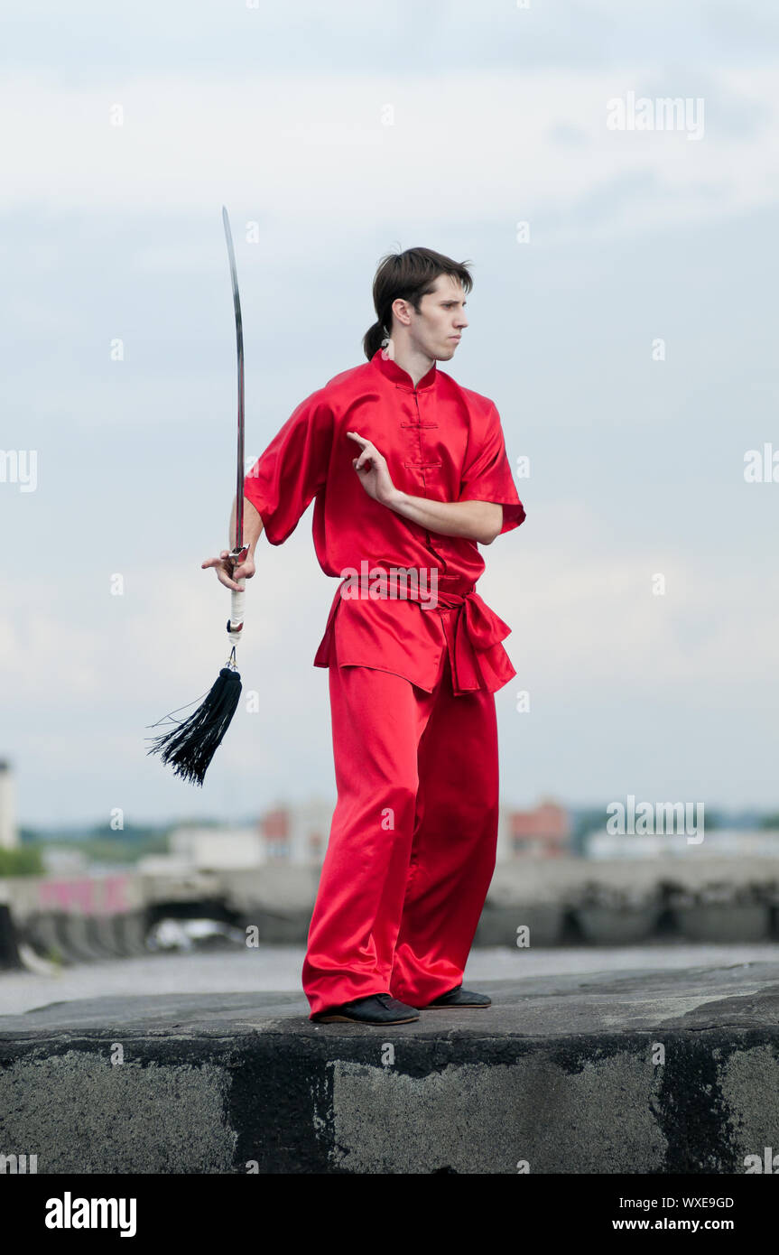 Shaolin warriors wushoo man in red with sword practice martial art ...