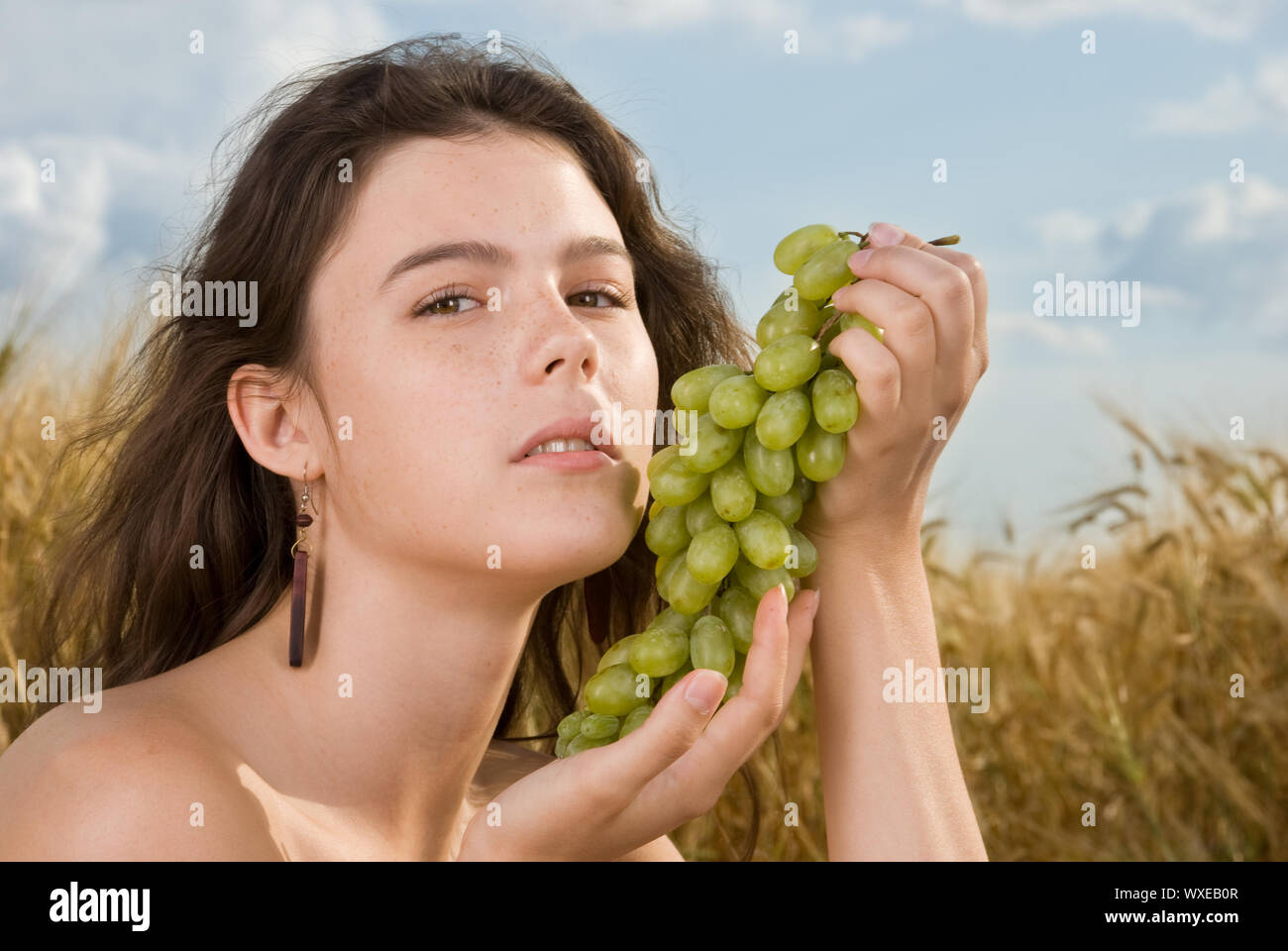 Beautiful slavonic girl on picnic in wheat field with grapes Stock ...