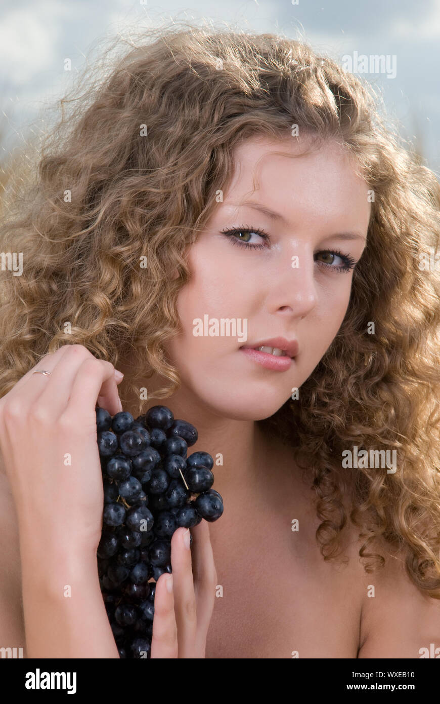 Beautiful slavonic girl on picnic in wheat field with grapes Stock ...