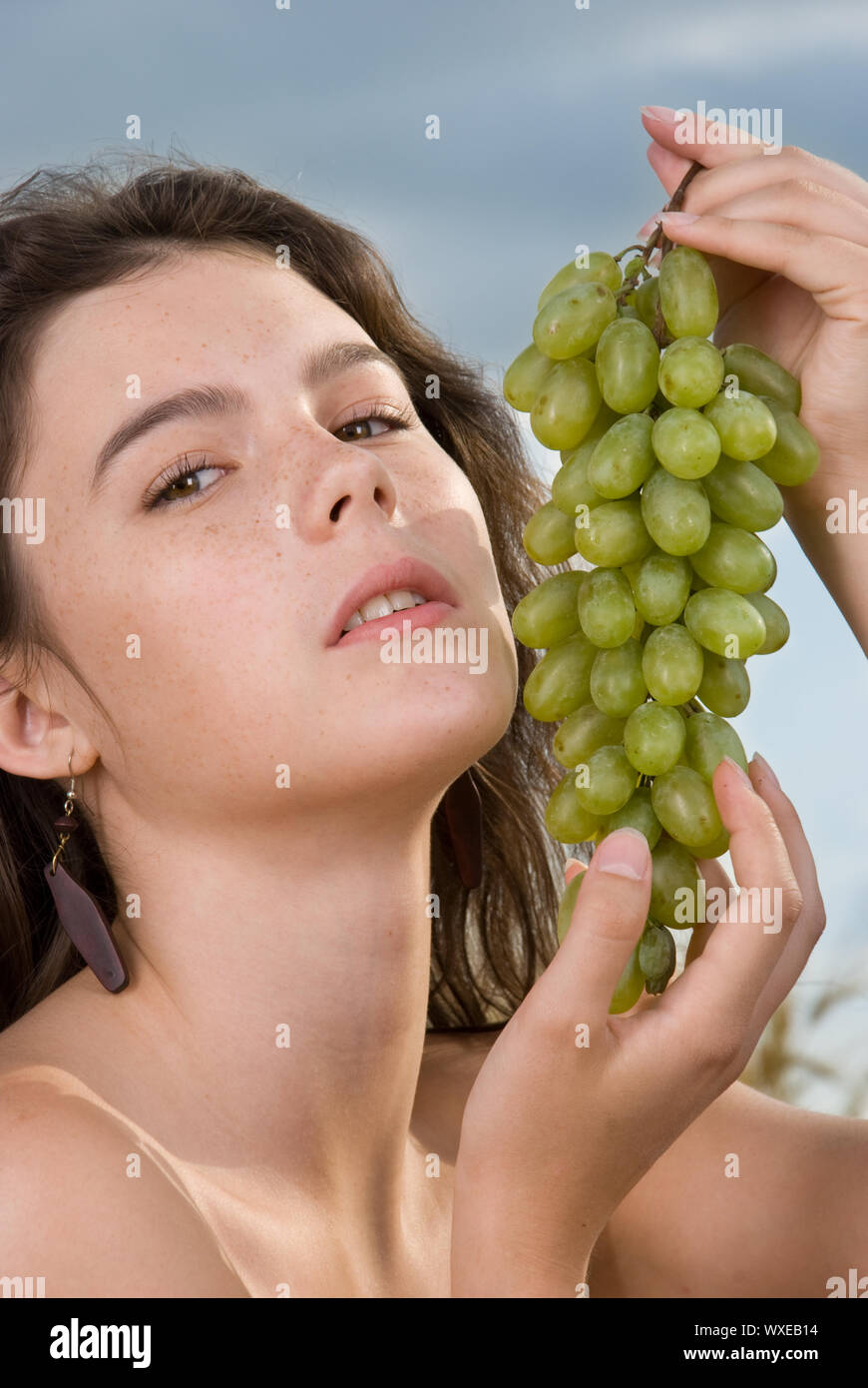 Beautiful slavonic girl on picnic in wheat field with grapes Stock ...