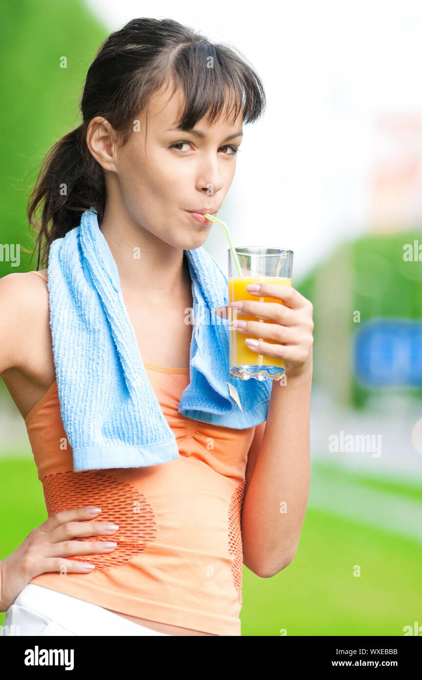 Teenage girl drinking orange juice after fitness exercise Stock Photo Alamy