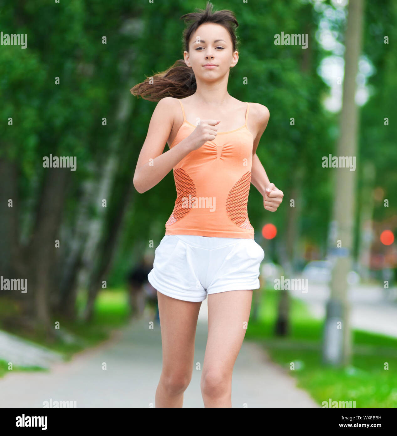 Sport Teenage Girl Running Outdoor. Young Woman Running In Field