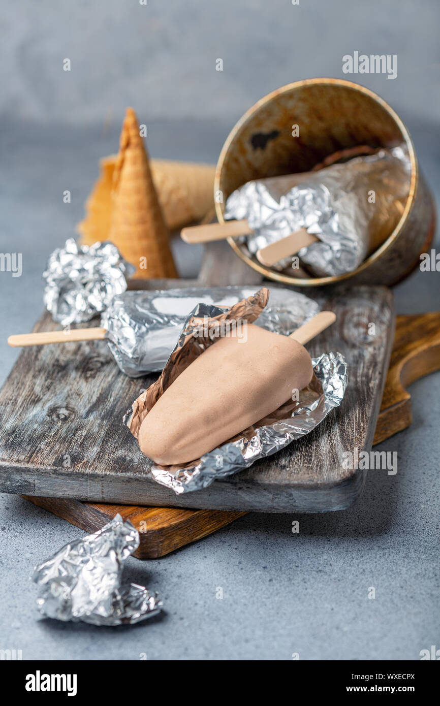 Homemade ice cream with chocolate icing on a stick. Stock Photo
