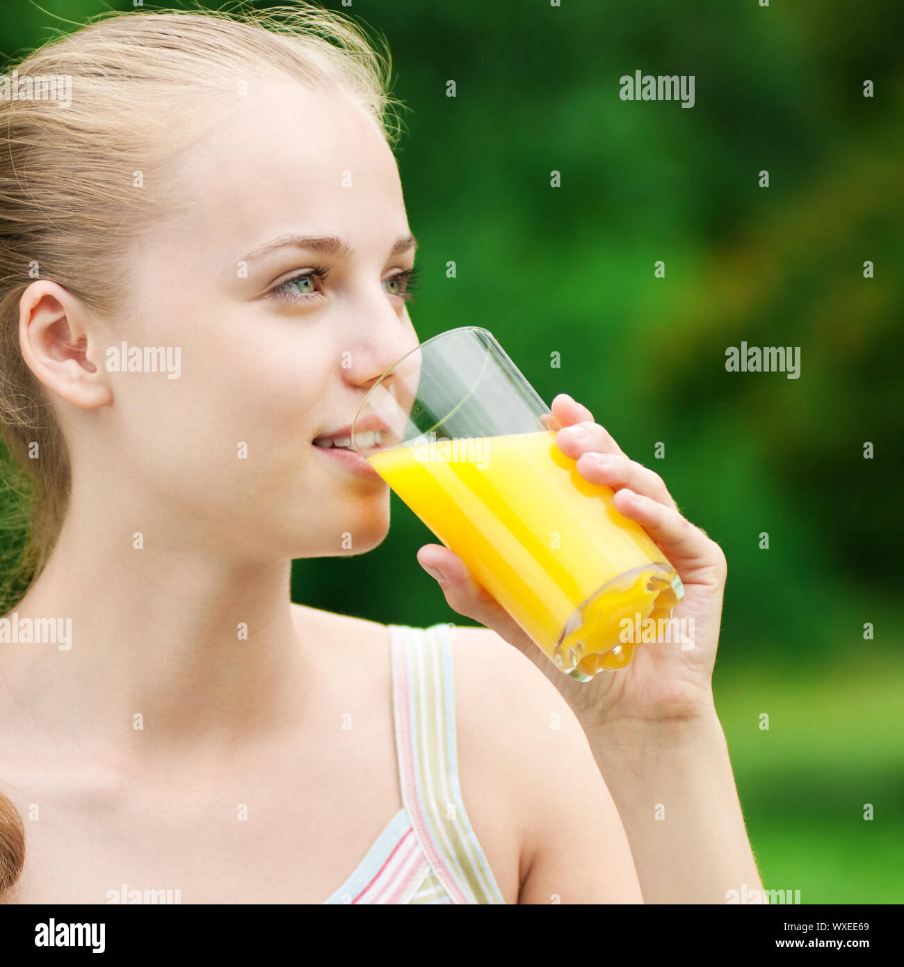 Young woman drinking orange juice after outdoor fitness exercise Stock Photo Alamy