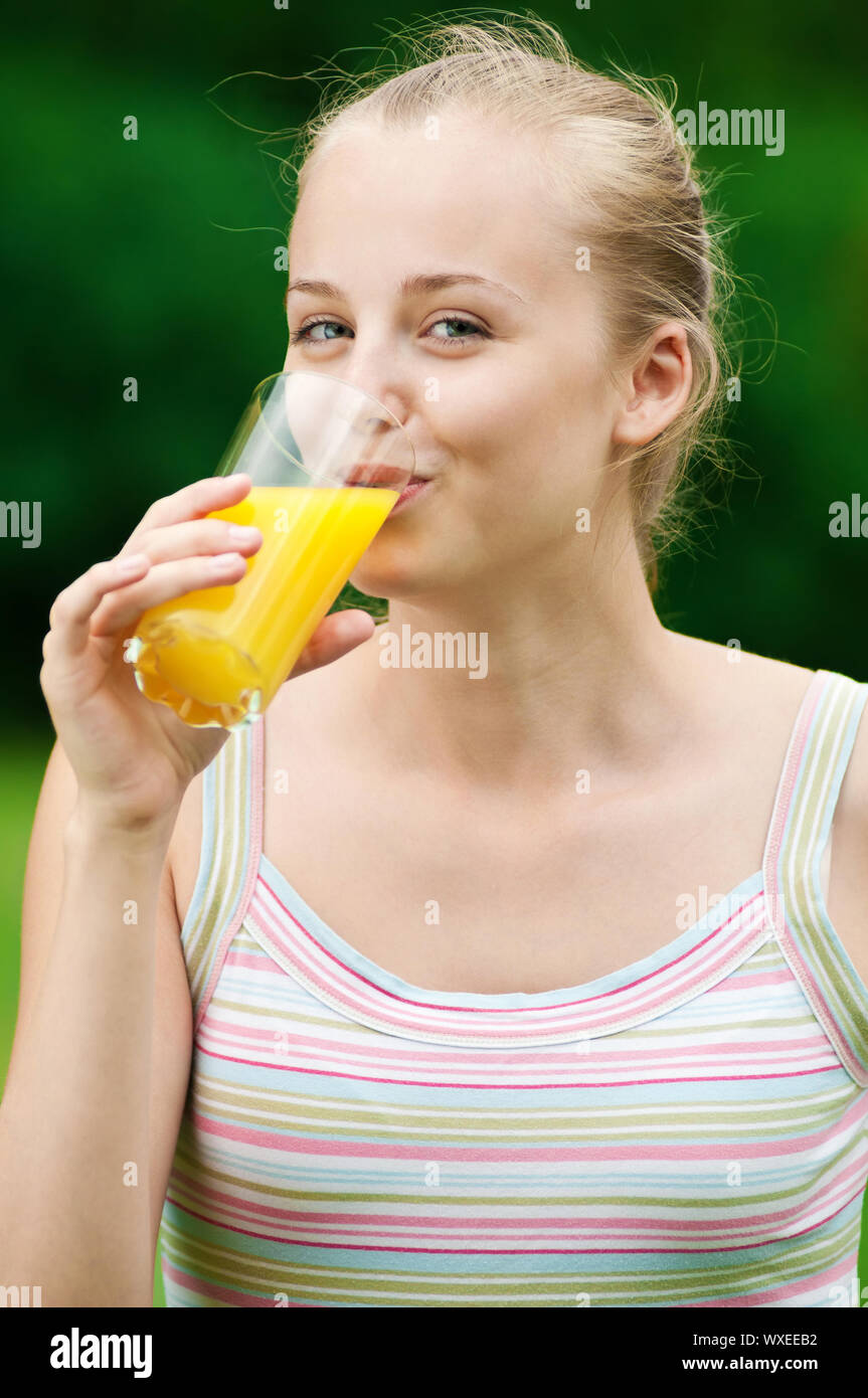 Young woman drinking orange juice after outdoor fitness exercise Stock Photo Alamy