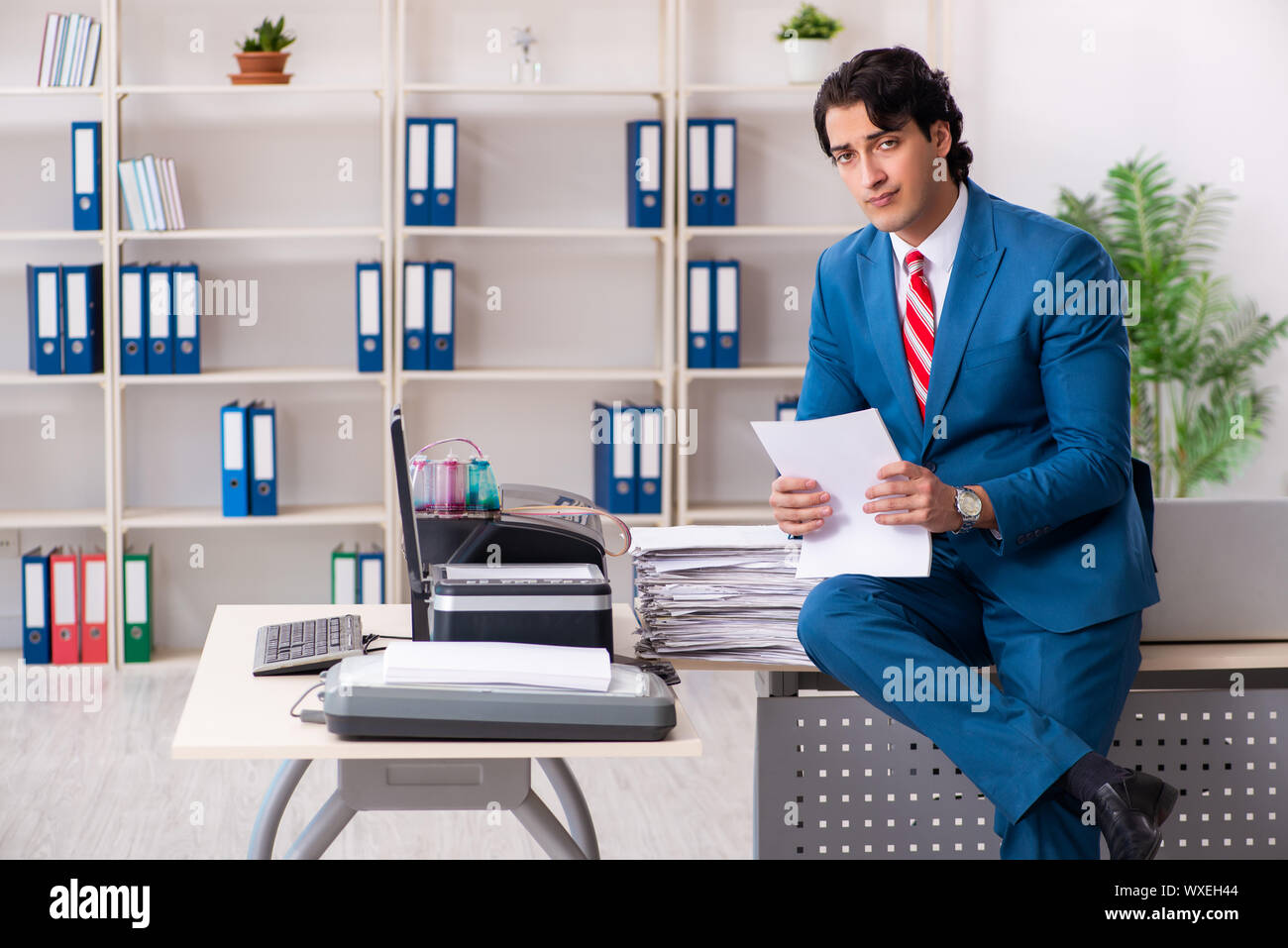 Working Copy Cop Young employee making copies at copying machine Stock Photo - Alamy