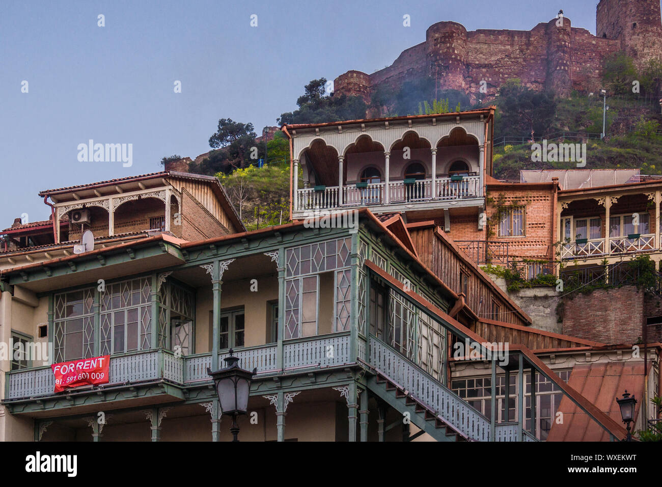old classic wooden balconies of colored wooden houses in tbilisi Stock Photo