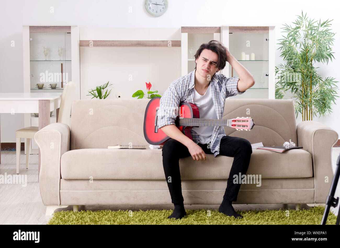 Young guitar player recording video for his blog Stock Photo