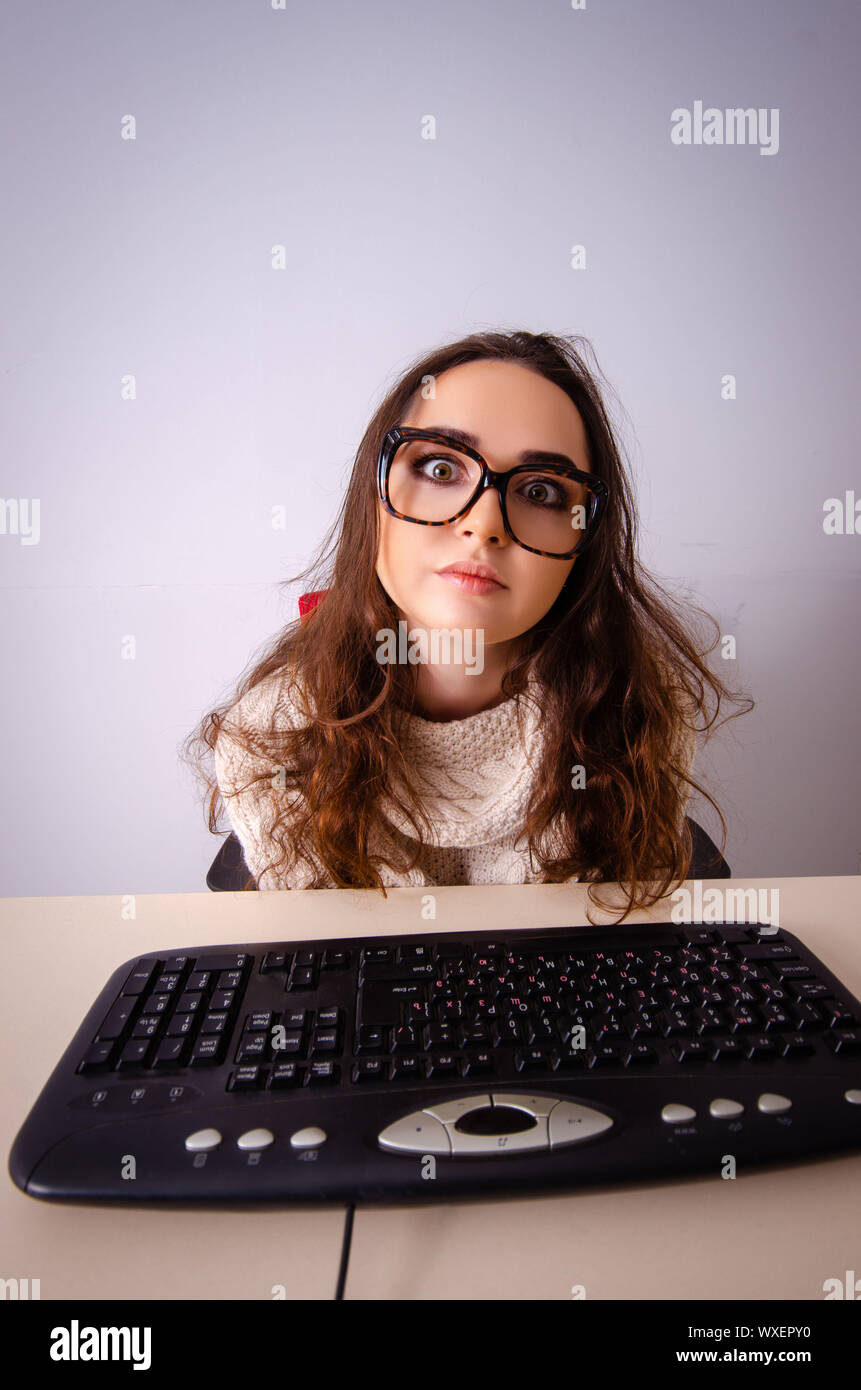 Funny nerd girl working on computer Stock Photo