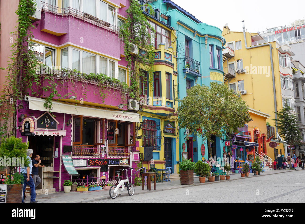 tourists and locals in the colorful Golden Horn neighborhood in Istanbul with shops and restaurants Stock Photo