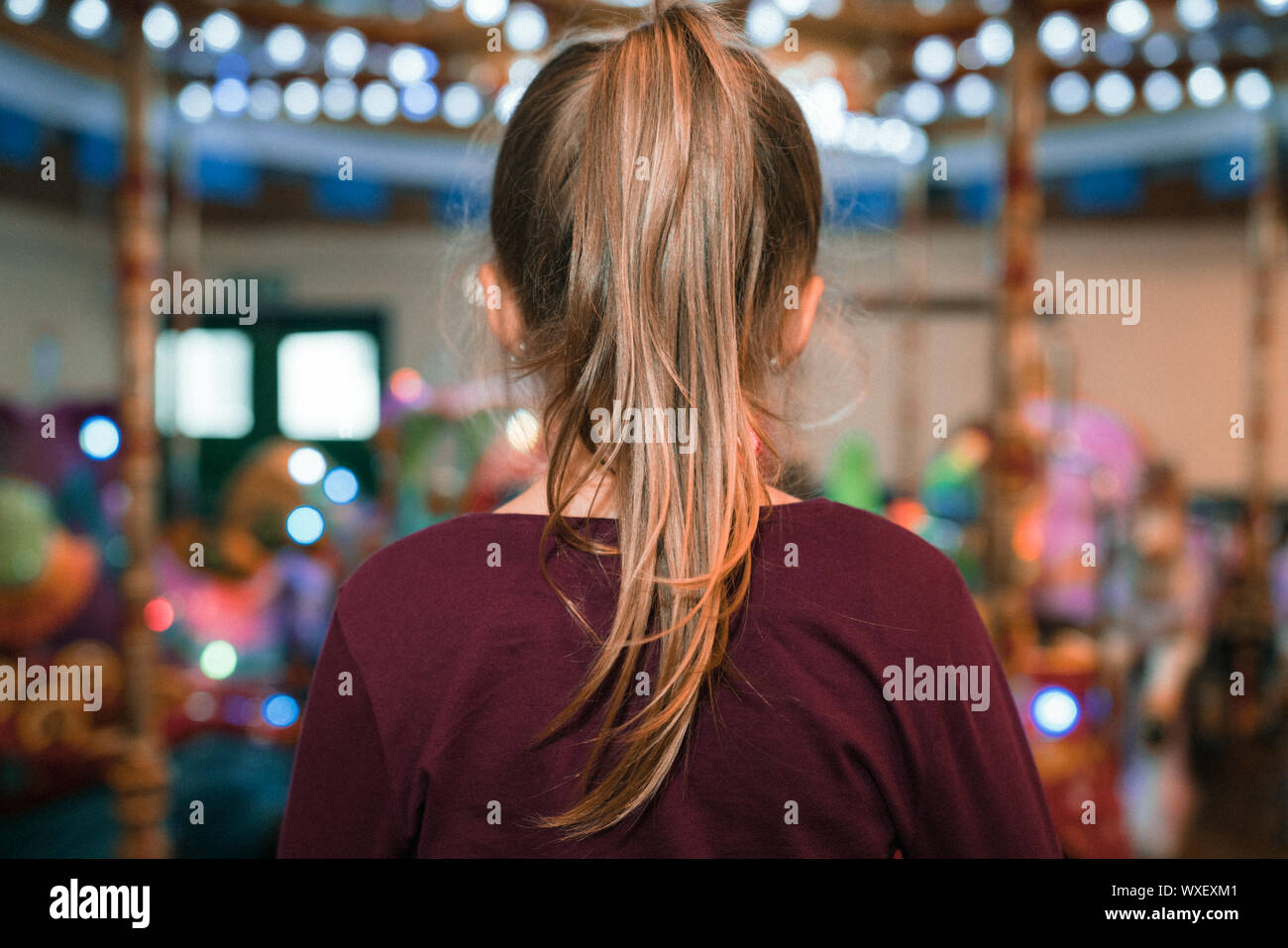 Girl with a ponytail in an  indoor amusement playground Stock Photo