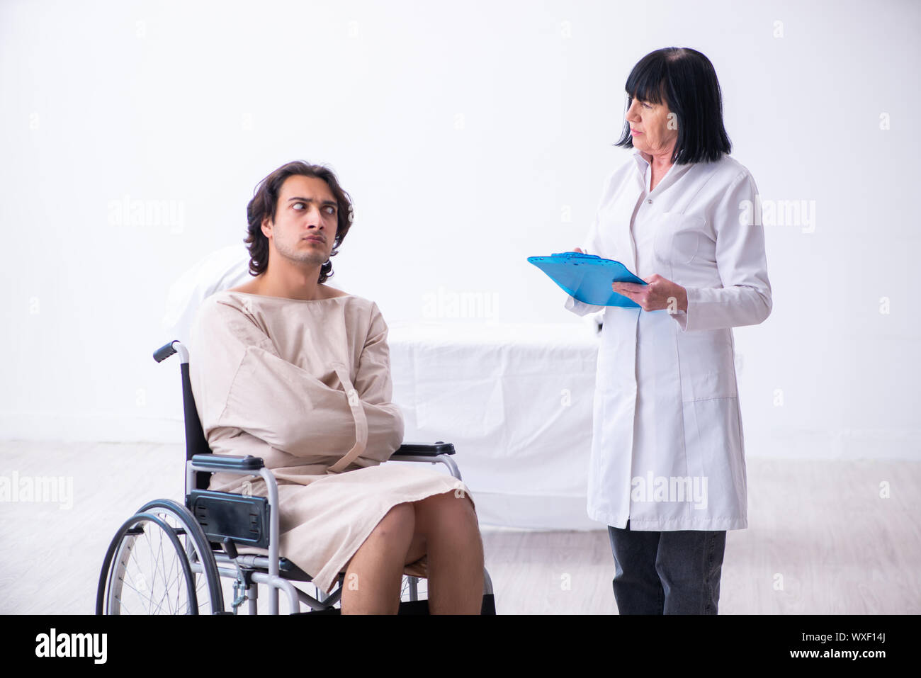 Old female psychiatrist visiting young male patient Stock Photo Alamy