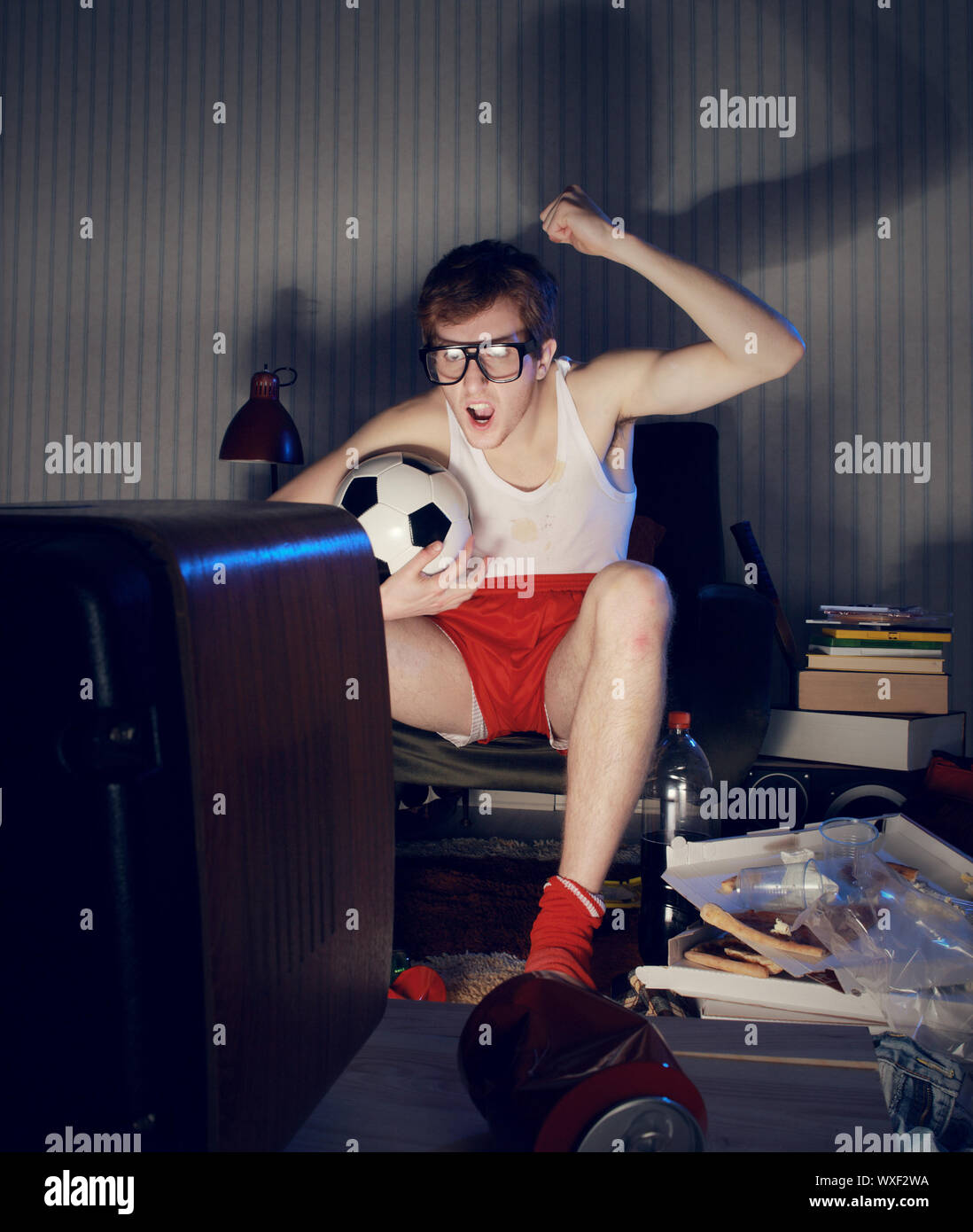 Nerd boy excited by goal scored during soccer competition Stock Photo