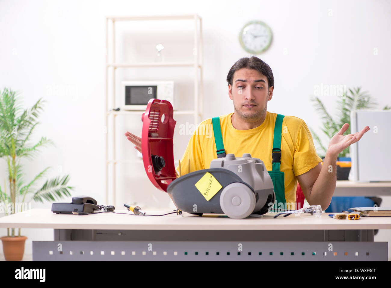 Man repairman repairing vacuum cleaner Stock Photo Alamy