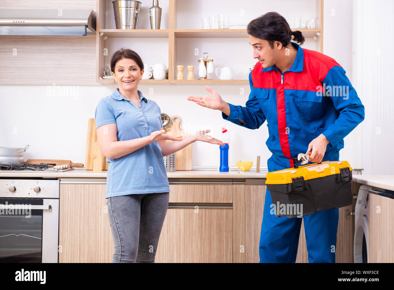 Young Male Repairman Repairing Washing Machine Stock Photo Alamy