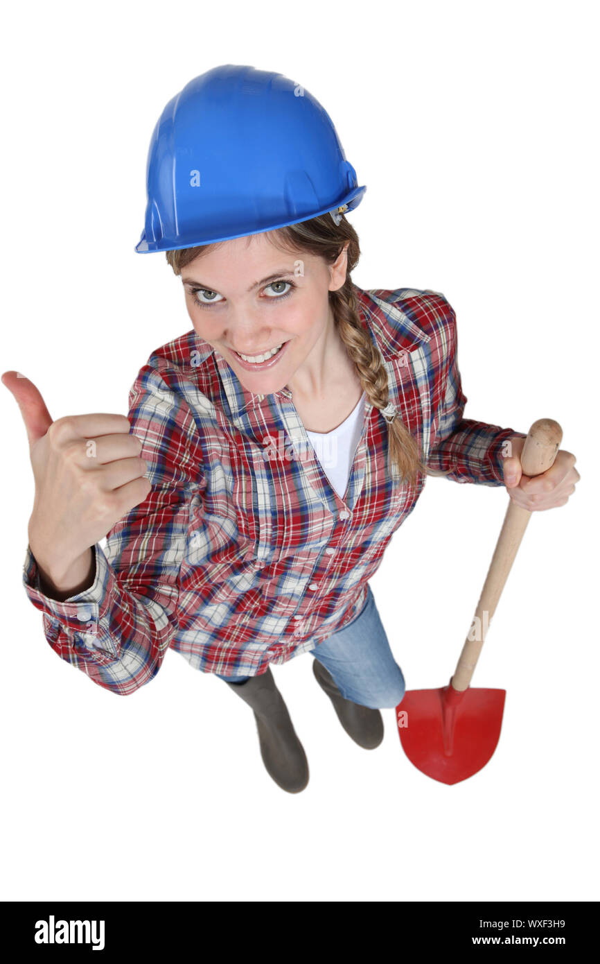 young female bricklayer holding shovel Stock Photo