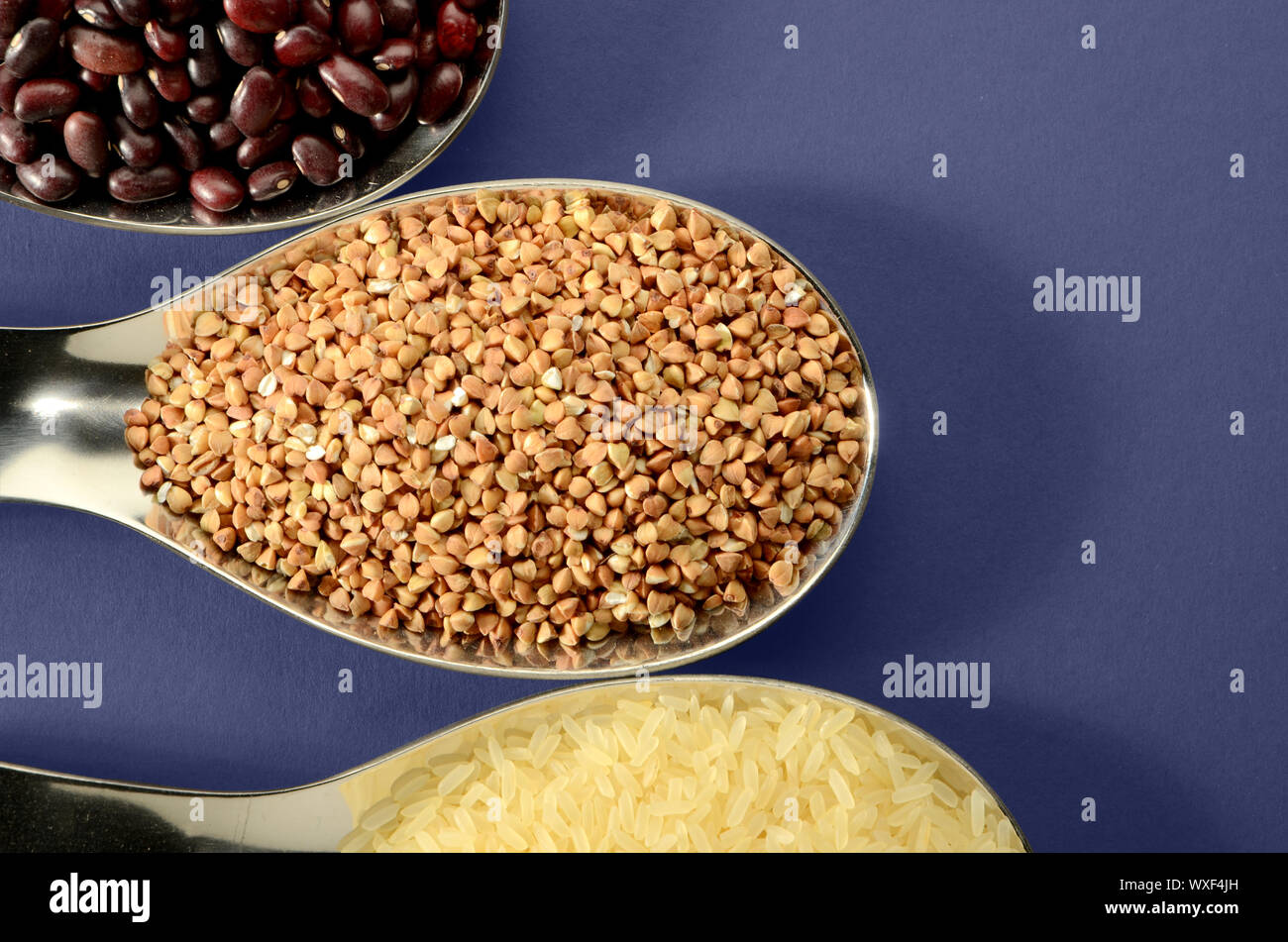 BEANS RICE BUCKWHEAT IN A SPOON Stock Photo