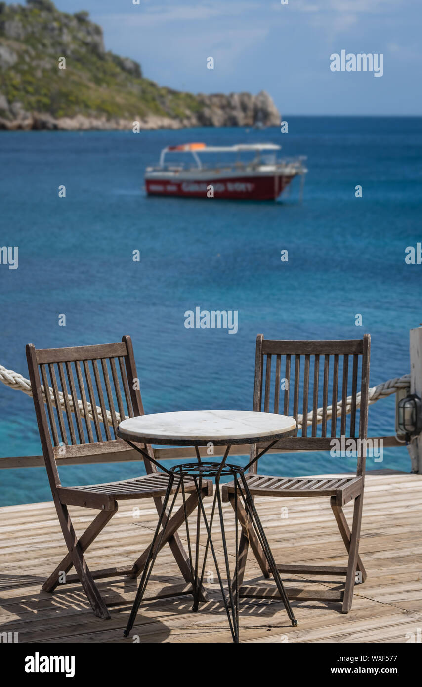 Wooden chairs and table on a deck platform Stock Photo - Alamy