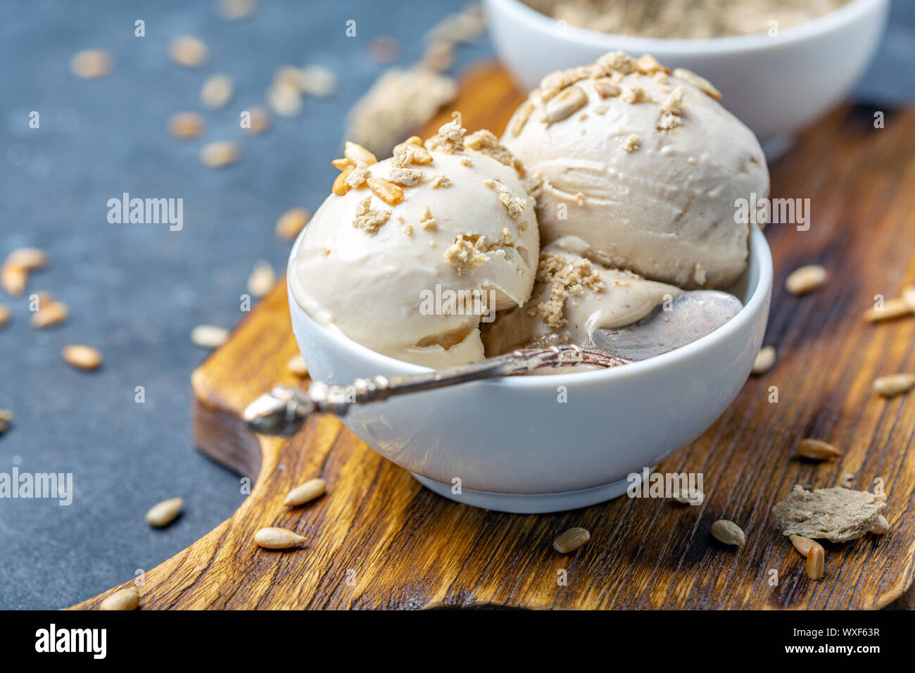 Ice cream with halva and sunflower seeds close up. Stock Photo