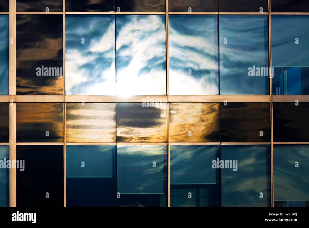 Reflection of a cloudy sky in glass wall of an office building Stock ...