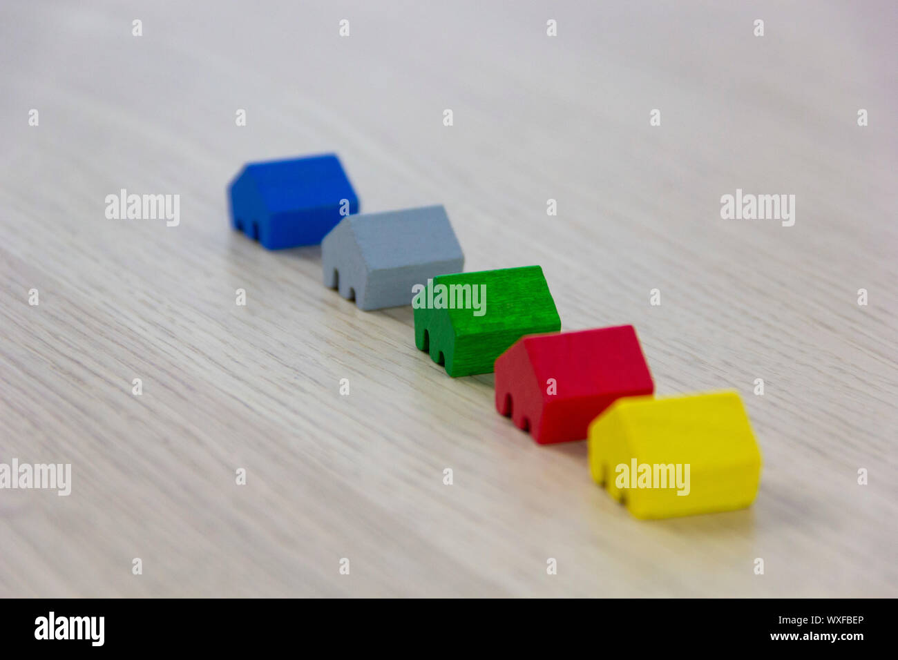 different colored game pieces representing different houses, concept of choice and diversity Stock Photo
