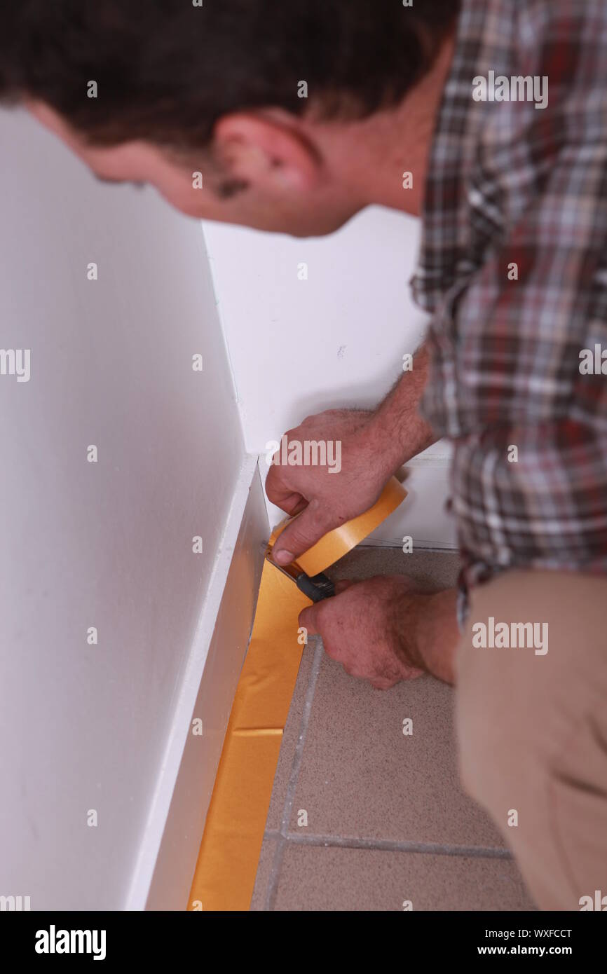 Man taping off wall Stock Photo Alamy