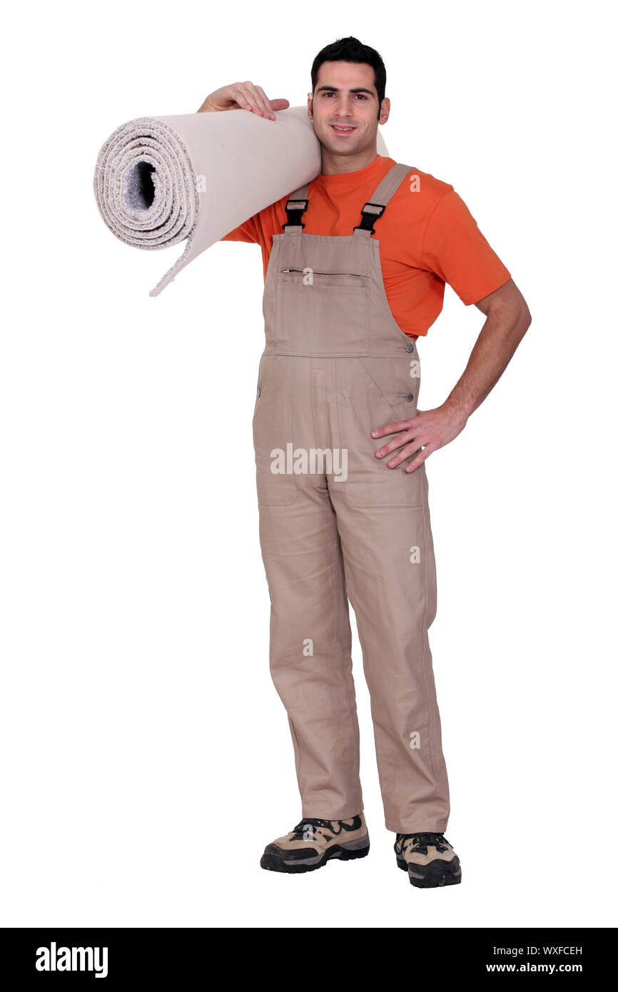 Man holding a roll of carpet Stock Photo