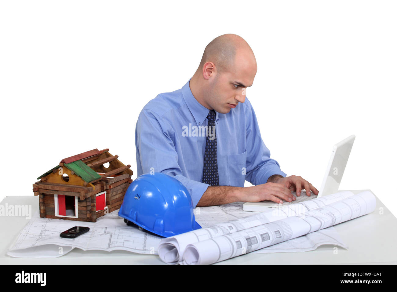 Architect sat at desk Stock Photo