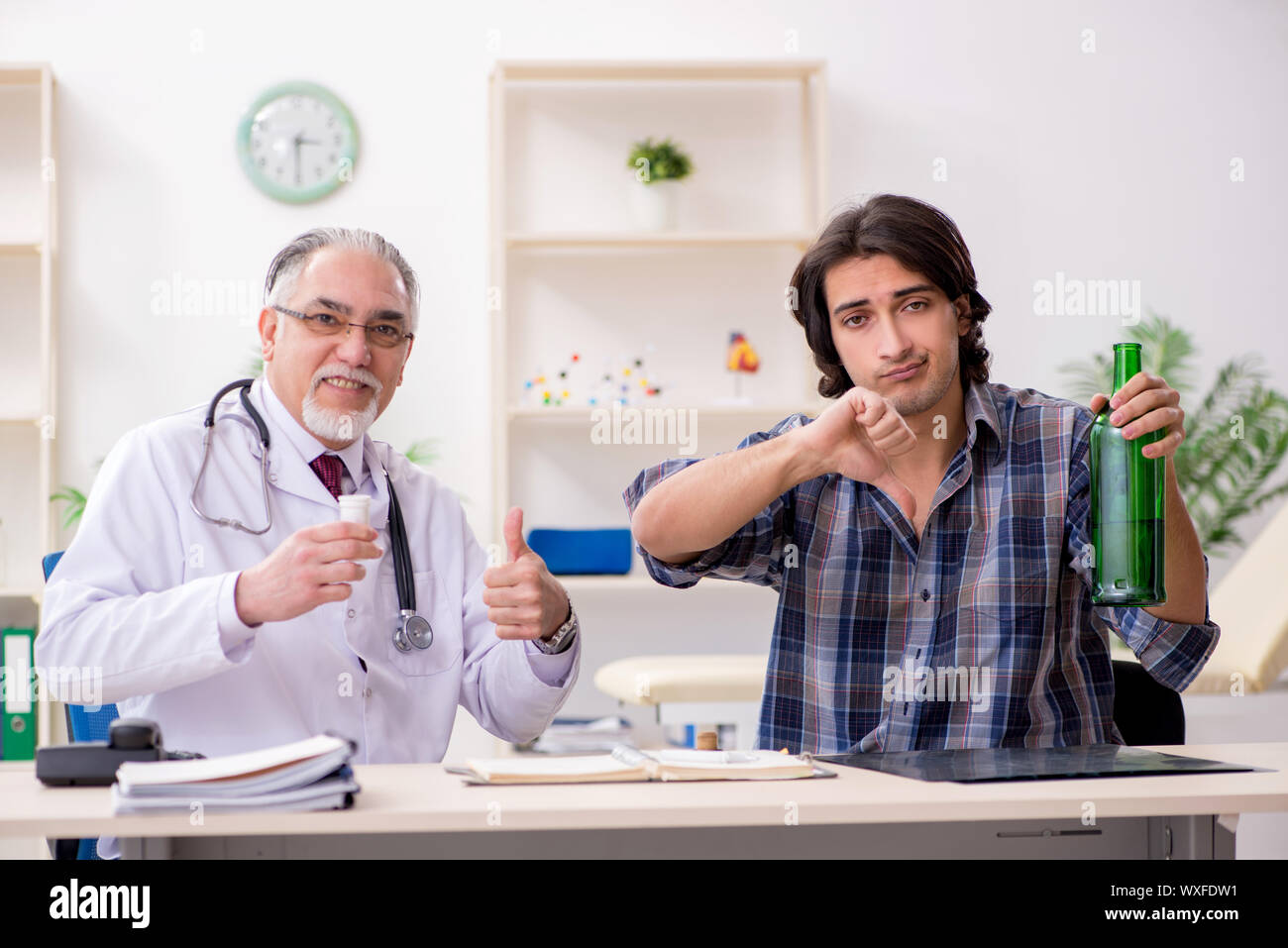 Young male alcoholic visiting old doctor Stock Photo