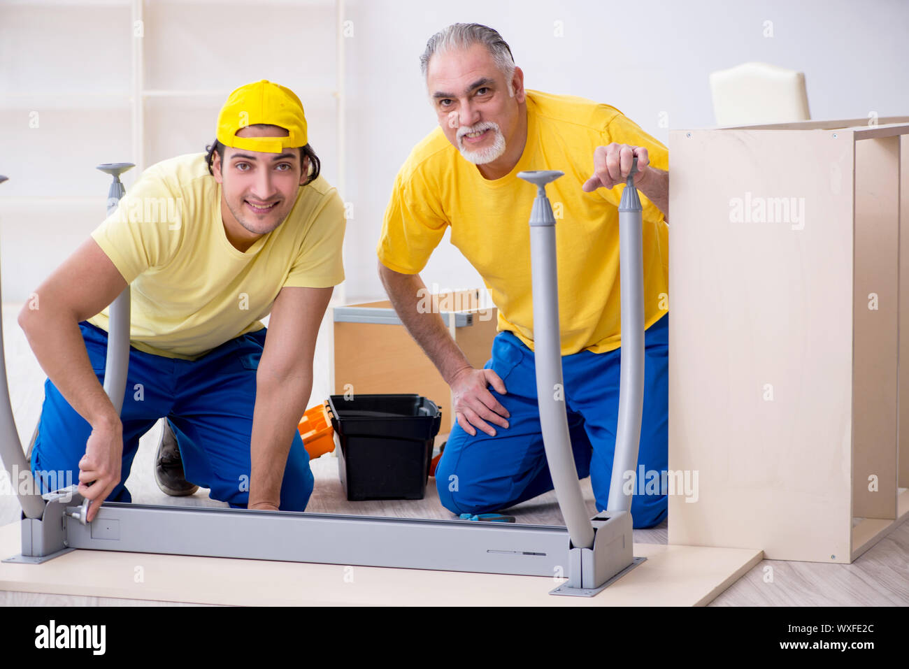 Two contractors carpenters working indoors Stock Photo Alamy