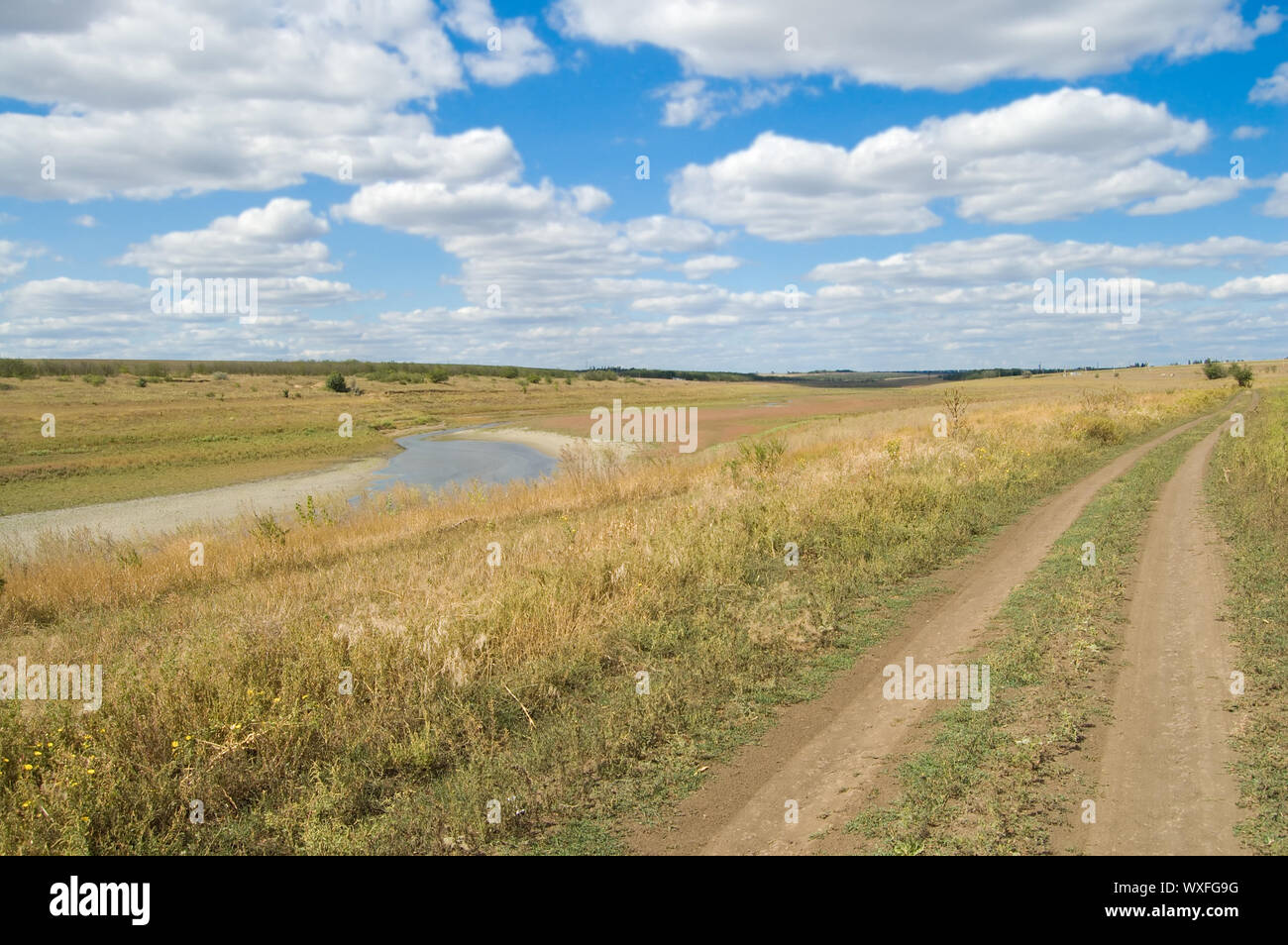 view of rural locality with a river and clouds in the background Stock Photo