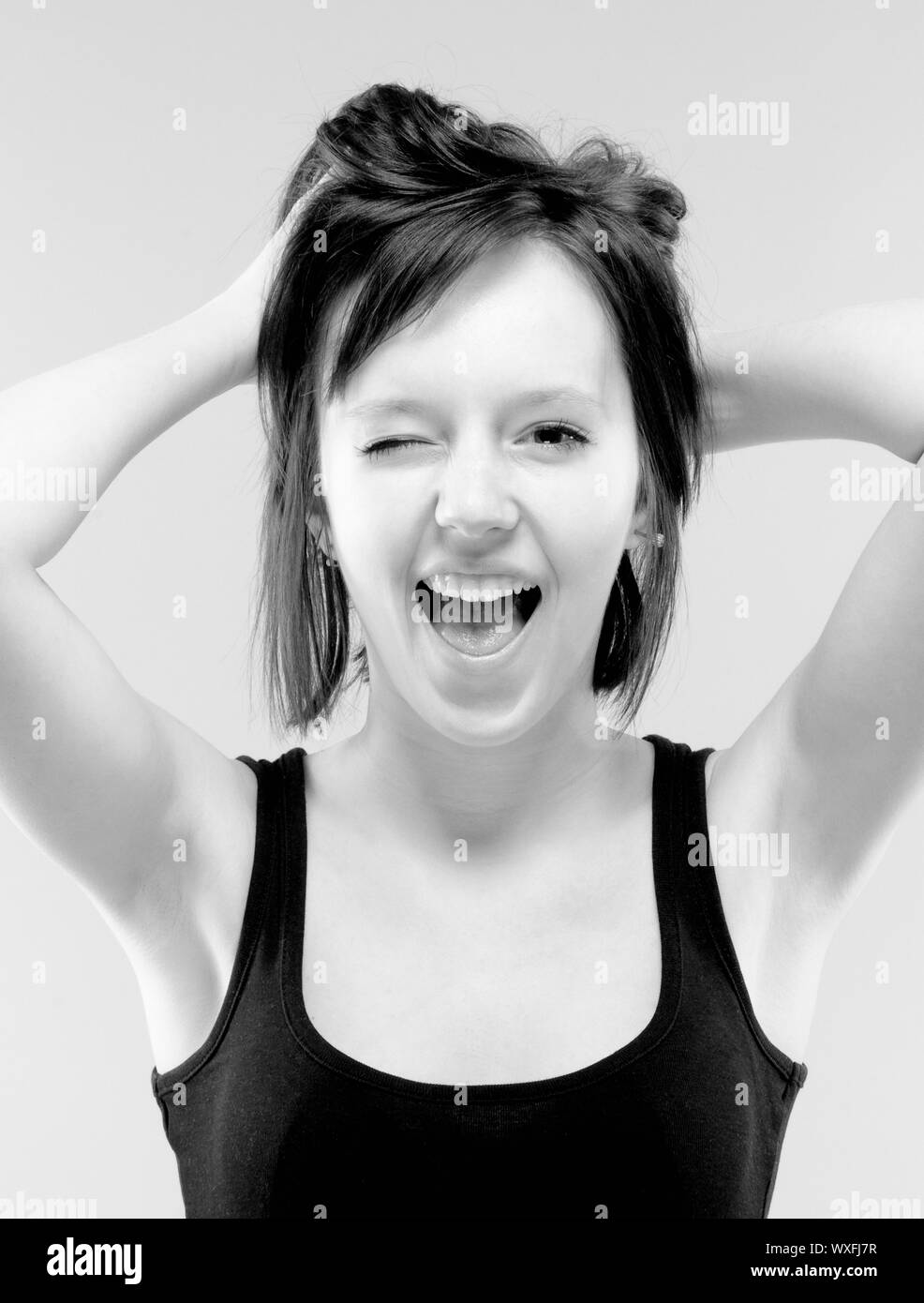 beautiful teenage girl in black screaming -  black and white Stock Photo