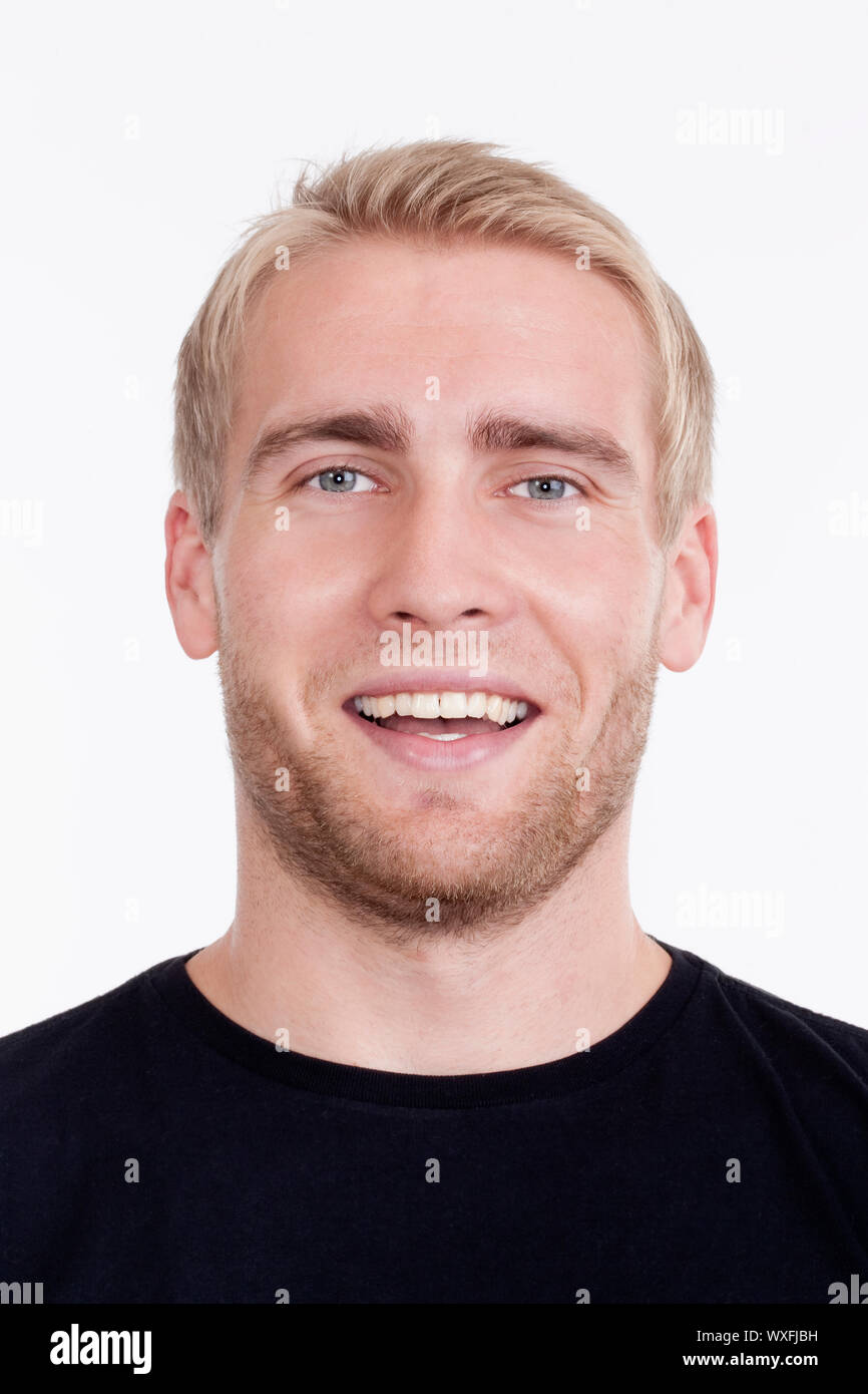 portrait of a young man with blond hair smiling - isolated on white ...