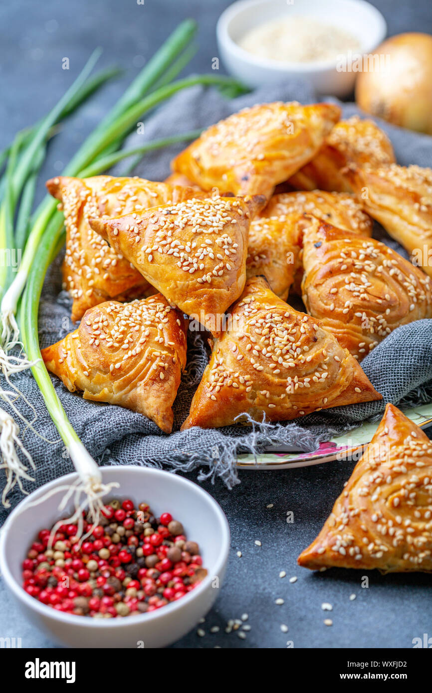 Samosas with meat sprinkle with sesame seeds. Stock Photo