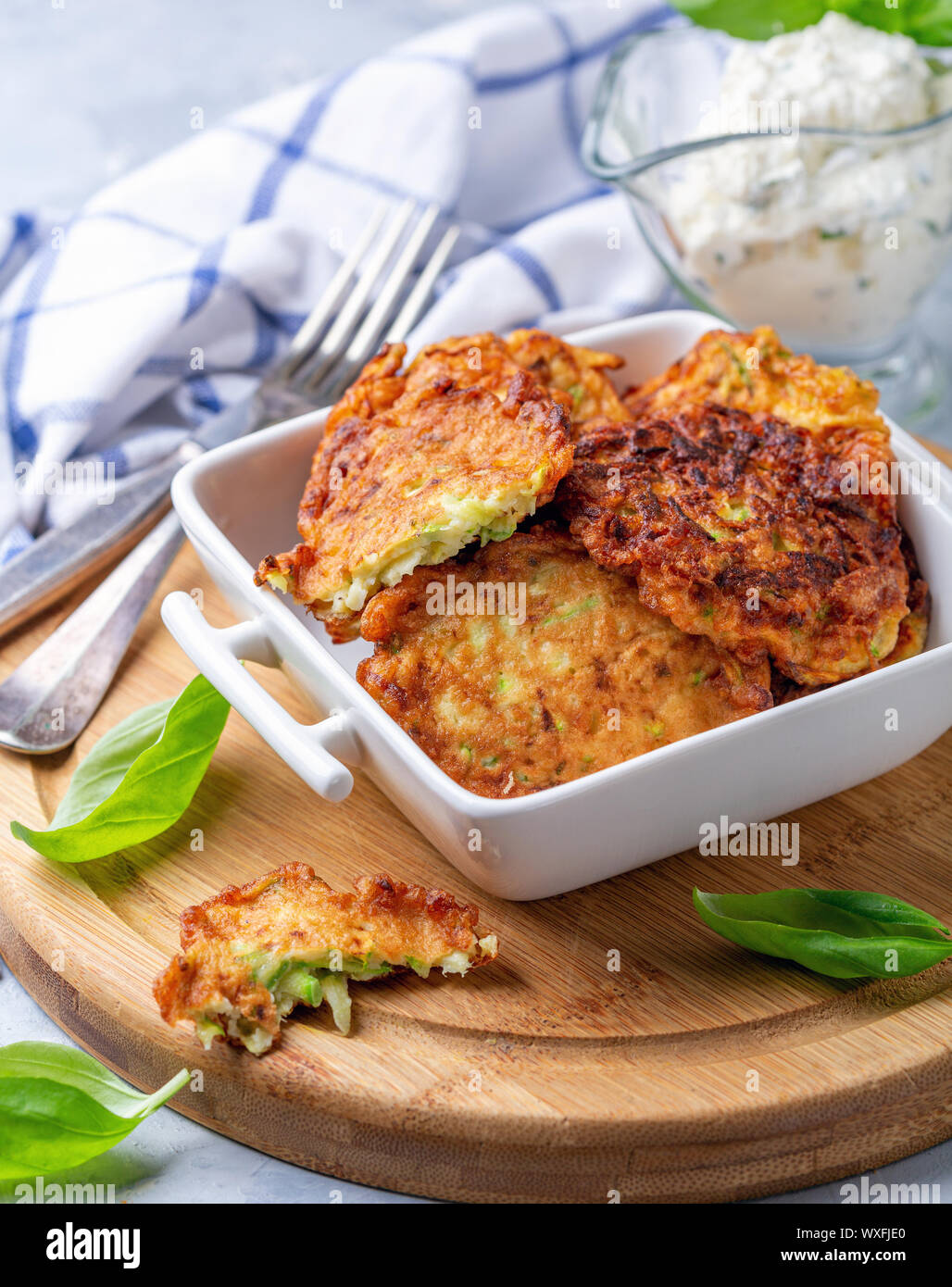 Zucchini fritters with sour cream sauce Stock Photo Alamy