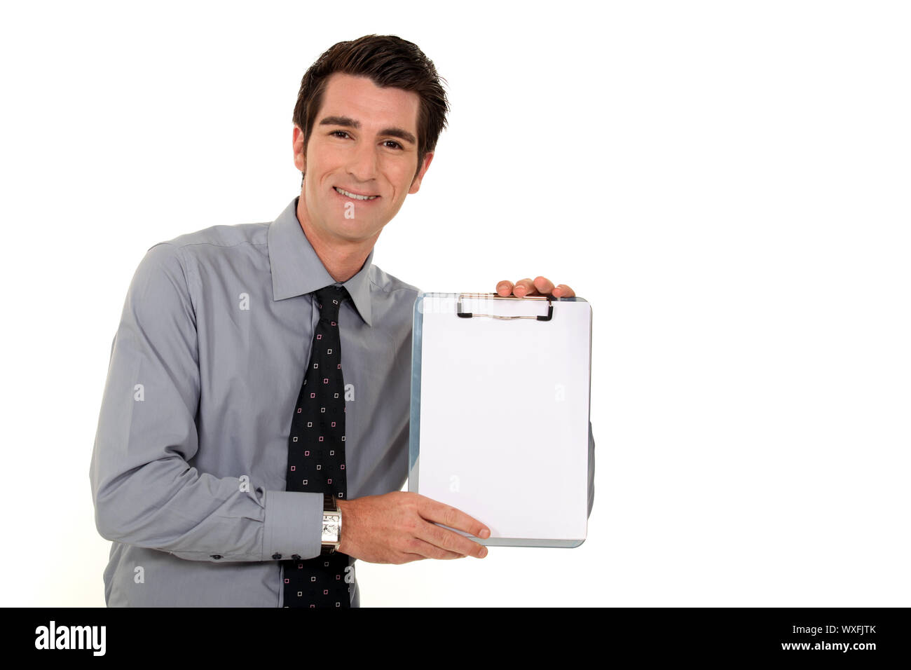 Businessman presenting clip-board Stock Photo - Alamy