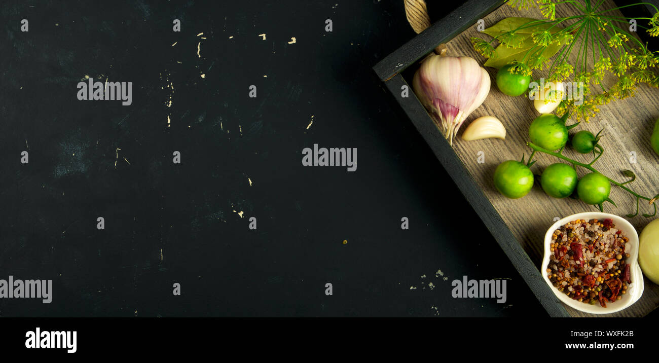 TEXTURE OF VEGETABLES IN A BOX ON A DARK BACKGROUND. CONCEPT OF PREPARING VEGETABLES FOR WINTER. Stock Photo