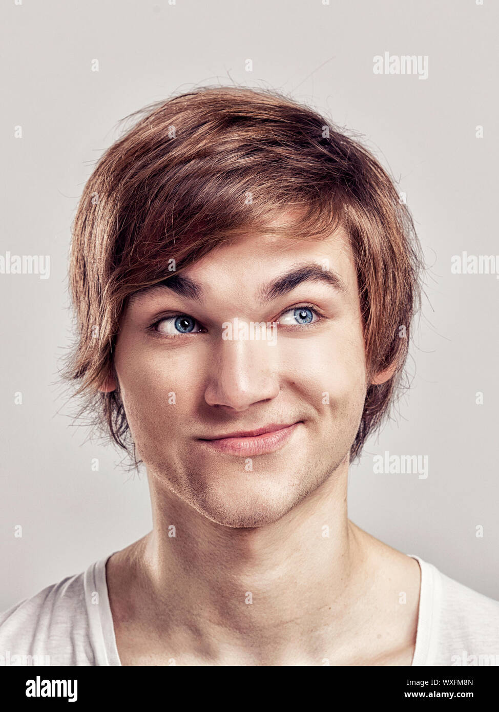 Portrait of a handsome young man, over a gray background Stock Photo ...