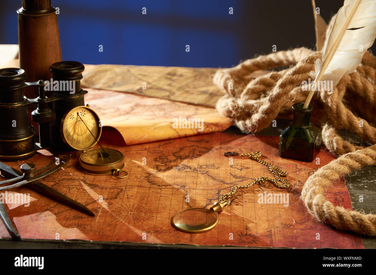 Medieval objects for navigation in the form of maps magnifying glass and compass Stock Photo