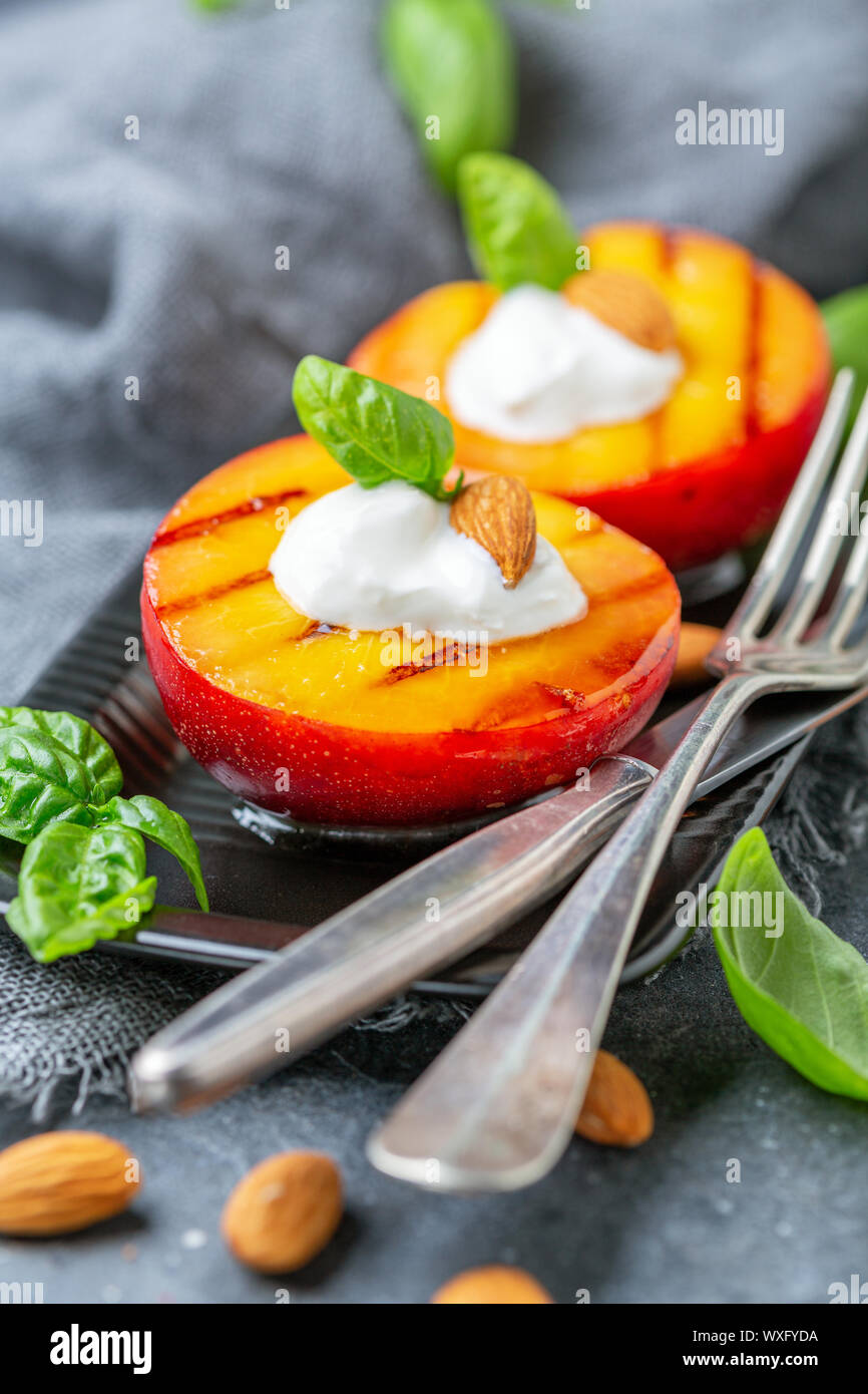 Fried peaches with yogurt, honey and almonds Stock Photo Alamy