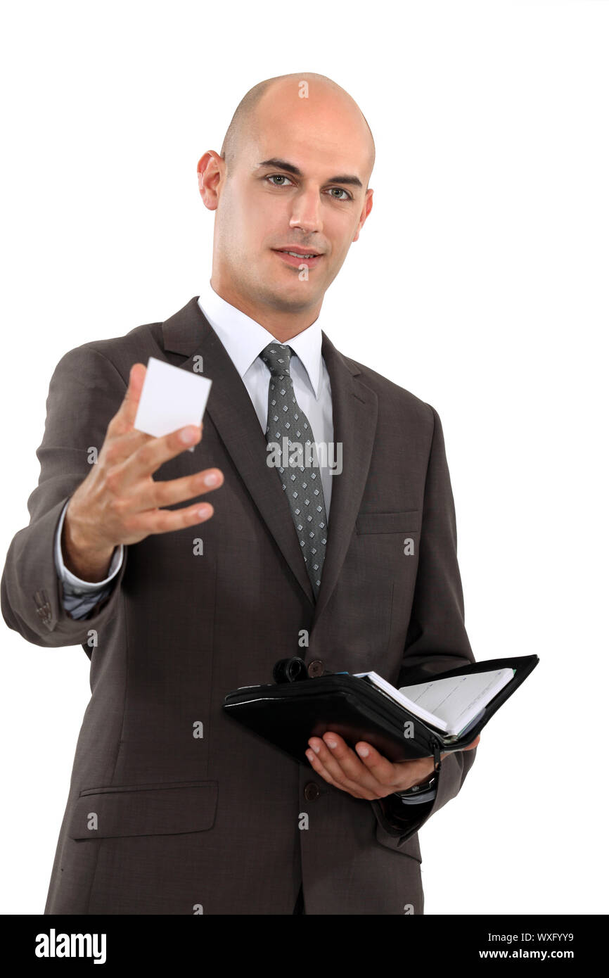 Businessman holding out his business card Stock Photo