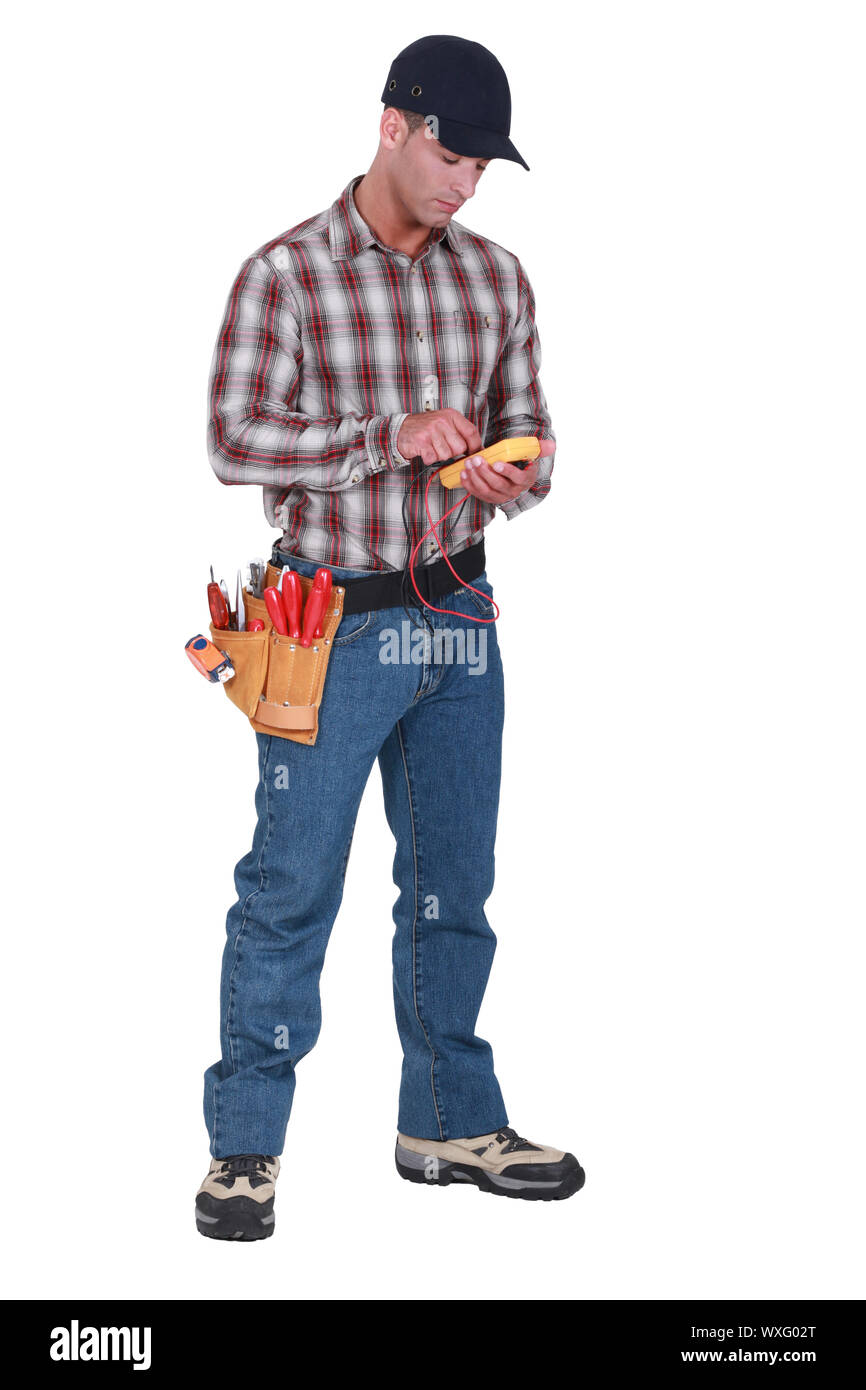 An electrician checking his voltmeter. Stock Photo