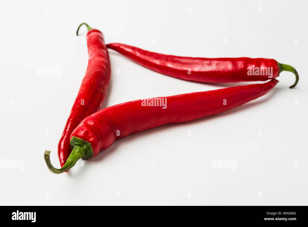 Red chili peppers on a white background Stock Photo - Alamy