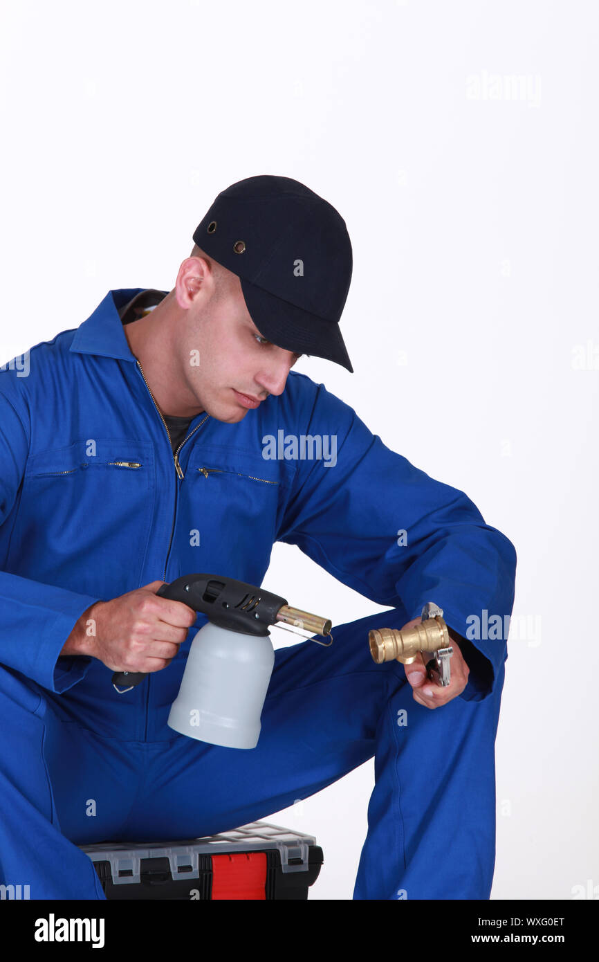 Plumber using blow torch on brass pipe Stock Photo Alamy
